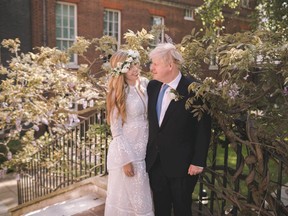 U.K. Prime Minister Boris Johnson and his bride Carrie Johnson are seen in the garden of 10 Downing St., after their wedding, in London on Saturday, May 29, 2021.