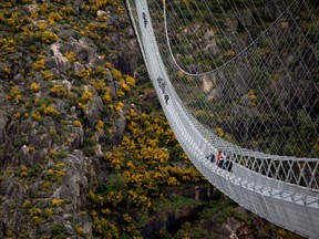 People walk on the world's longest pedestrian suspension bridge '516 Arouca', in Arouca, Portugal on April 29