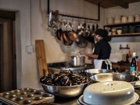 A cook works in a restaurant kitchen. "It's now up to restaurant owners to increase pay scales so that more cooks will find it possible to enter and remain in the sector," David Ferguson writes.