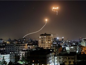 A streak of light appears as Israel's Iron Dome anti-missile system intercepts rockets launched from the Gaza Strip on Sunday, May 16, 2021.  The heaviest exchange of fire in years, sparked by unrest in Jerusalem, has killed 192 in the crowded coastal enclave of Gaza since the beginning of this week along with 10 in Israel, according to authorities on either side.