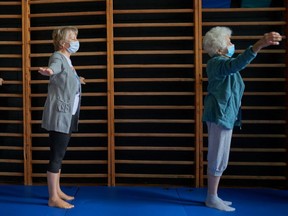 Patients exercise at the wall bars during a therapy session for long COVID at the John Paul II Specialists Hospital in Poland. Other countries have long COVID programs, but little is available so far in Quebec.