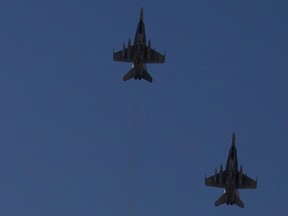 Two CF-18 jets fly over Montreal in 2011.