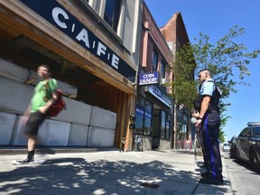 FILE - Toronto police special constables guard closed-down Bloor St. W. CAFE cannabis dispensary after crews with heavy machinery attempted to remove concrete blocks sealing the entrance on Thursday, July 18 2019.