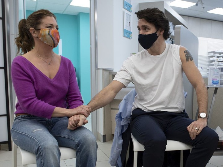  Sophie Gregoire Trudeau holds her husband’s hand as Prime Minister Justin Trudeau prepares to receive his COVID-19 AstraZeneca vaccination at a pharmacy in Ottawa on Friday April 23, 2021.