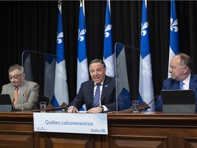 Quebec Premier Francois Legault smiles as he announces the deconfinement plan for the coming months, during a news conference on the COVID-19 pandemic on May 18, 2021
