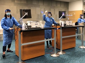 Public Health Agency of Canada staff stand at their positions to demonstrate internation arrival procedures for coronavirus testing and quarantines at Vancouver International Airport in Richmond, British Columbia, Canada February 21, 2021. Picture taken February 21, 2021.   CBSA/Handout via REUTERS. THIS IMAGE HAS BEEN SUPPLIED BY A THIRD PARTY.