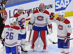 Montreal Canadiens' Jeff Petry, from left, Tyler Toffoli, Carey Price and Joel Edmundson celebrate their win over the Toronto Maple Leafs in Game 1 of the their North Division semifinal series in Toronto on May 20, 2021.