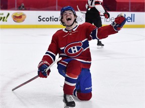 The Canadiens’ Cole Caufield celebrates after scoring his first NHL goal in overtime for a 3-2 win over the Ottawa Senators Saturday night at the Bell Centre.