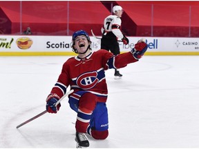 The Canadiens’ Cole Caufield celebrates after scoring his first NHL goal, giving the Habs a 3-2 overtime win over the Ottawa Senators Saturday night at the Bell Centre.