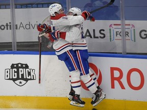 Montreal Canadiens' Nick Suzuki, left, celebrates scoring the winning goal against Toronto Maple Leafs in overtime with forward Cole Caufield in Game 5 at Scotiabank Arena in Toronto on May 27, 2021.