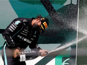 Mercedes' Lewis Hamilton celebrates on the podium after winning the Portuguese Grand Prix on May 2, 2021.