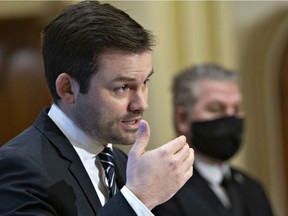 Parti Quebecois Leader Paul St-Pierre Plamondon speaks at a news conference as the party meets for a pre-session caucus, Monday, January 25, 2021 at the legislature in Quebec City. Parti Quebecois Leader Pascal Berube, right, looks on.