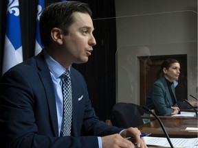 Quebec Justice Minister Simon Jolin-Barrette announces funding to fight domestic violence, Thursday, May 6, 2021 at the legislature in Quebec City. Quebec Deputy premier and Public Security Minister Genevieve Guilbault, right, looks on.