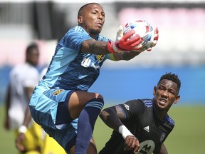 Columbus Crew SC goalkeeper Eloy Room (1) controls the ball against CF Montreal during the first half at DRV PNK Stadium in Fort Lauderdale, Fla., on May 1, 2021.