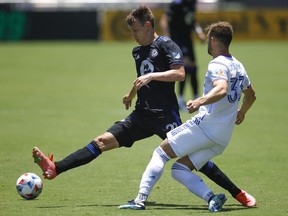 FC Cincinnati midfielder Caleb Stanko (33) passes the ball around CF Montréal midfielder Lassi Lappalainen (21) during the first half at DRV PNK Stadium in  Fort Lauderdale, Fla., on Saturday, May 22, 2021.