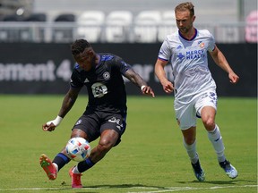 CF Montréal forward Romell Quioto (30) takes a shot on goal in front of FC Cincinnati midfielder Caleb Stanko (33) during the second half at DRV PNK Stadium in Fort Lauderdale, Fla., on Saturday, May 22, 2021.