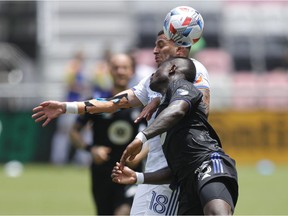 FC Cincinnati defender Ronald Matarrita (18) and CF Montreal defender Zachary Brault-Guillard battle for the ball during second half of Montreal's loss at Fort Lauderdale, Fla., on May 22, 2021.