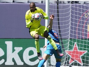 CF Montréal goalkeeper Clement Diop (23) makes a save against Chicago Fire midfielder Luka Stojanovic (8) during the second half at Soldier Field in Chicago on Saturday, May 29, 2021.