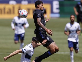 CF Montréal forward Bjorn Johnsen (9), top and Vancouver Whitecaps defender Cristian Gutierrez (3) battle for the ball in the first half at Rio Tinto Stadium on Saturday, May 8, 2021, in Sandy, Utah.