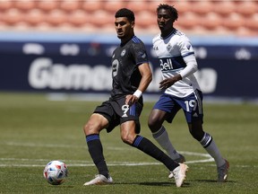 CF Montréal forward Bjorn Johnsen (9) and Vancouver Whitecaps midfielder Janio Bikel vie for the ball in the second half at Rio Tinto Stadium Sandy, Utah, on May 8, 2021.
