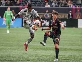 Montréal forward Romell Quioto (30) kicks the ball past Atlanta United midfielder Emerson Hyndman (20) during the second half at Mercedes-Benz Stadium on Saturday, May 15, 2021, in Atlanta.