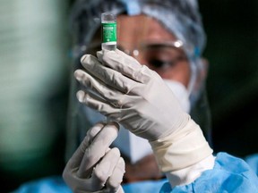 A health official draws a dose of the AstraZeneca's COVID-19 vaccine.