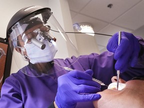 A dentist works on a patient. "After conclusive evidence was presented at a conference in 1982 in Toronto, the dental community began to embrace titanium implants, from which by now millions have benefitted," Joe Schwarcz writes.