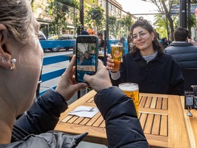 The Burgundy Lion's terrasse was full at 8 a.m. on Notre-Dame St. in Montreal on Friday May 28, 2021, the day restaurant terrasses were allowed to reopen. Beatrice Bernard-Poulin, left, captured the moment with her friend Chloe El-Sayegh.