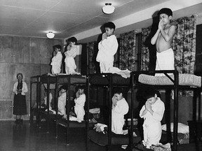 Indian Residential School students being forced to pray before bed.