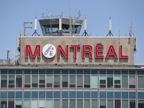 The Montreal sign atop the Pierre Elliott Trudeau Airport bears the drawing of a Covid-19 vaccination, in Montreal, on May 28, 2021.