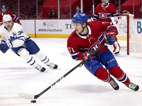Canadiens centre Jake Evans (71) is followed to the board by Toronto Maple Leafs centre Auston Matthews (34) during Game 6 playoff action in Montreal on Saturday, May 29, 2021.