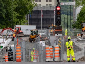A construction worker surveys the construction on Peel St. between St-Antoine St. and René-Lévesque Blvd. in Montreal on Tuesday June 1, 2021.