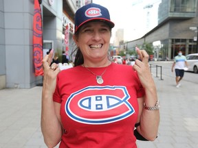 Sylvie Fleury has her fingers crossed as she waits for the Montreal Canadiens to begin Game 1 of their second round playoff series against the Winnipeg Jets Wednesday June 2, 2021.  Martel was at the Cage aux Sports outside the Bell Centre in downtown Montreal.