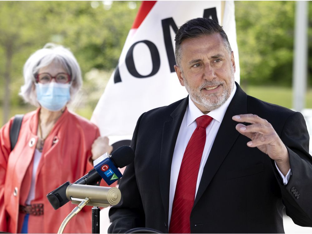 Pierrefonds-Roxboro Mayor Jim Beis, seen here at a news conference last summer, is seeking authority to preside over local marriages.