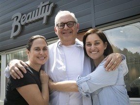 New sign, same font: Larry Sckolnick with daughters Julie, left, and Elana outside the renovated Beautys, which is to reopen at the end of June.