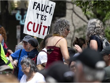 Several thousand people march in the street to protest public health measures and mask regulations in Montreal on Saturday, June 5, 2021.