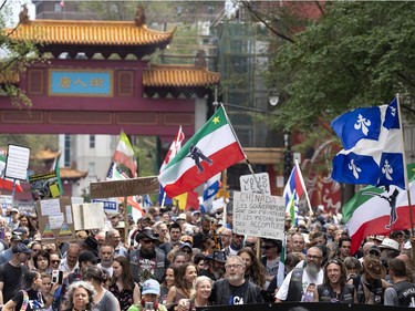 Several thousand people march in the street to protest public health measures and mask regulations in Montreal on Saturday, June 5, 2021.