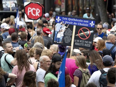 Several thousand people march in the street to protest against public health measures and mask regulations in Montreal on Saturday, June 5, 2021.