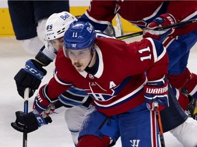 Canadiens' Brendan Gallagher (11) holds off Winnipeg Jets' Mathieu Perreault during round two, Game 3 of NHL playoff action in Montreal on Sunday, June 6, 2021.