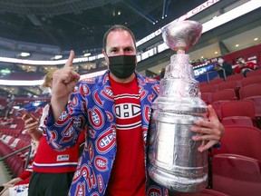 Montreal Canadiens fan Andy Mein brought a copy of the Stanley Cup to the team's  playoff game against the Winnipeg Jets in Montreal on Monday, June 7, 2021.
