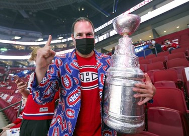 Montreal Canadiens fan Andy Mein brought a copy of the Stanley Cup to the team's  playoff game against the Winnipeg Jets in Montreal on Monday, June 7, 2021.