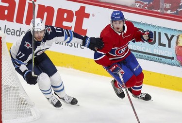 Alexander Romanov and Winnipeg Jets' Adam Lowry head up ice during third period in Montreal Monday, June 7, 2021.