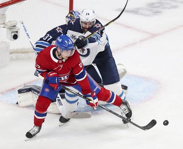 Artturi Lehkonen tips the puck past Winnipeg Jets defenceman Derek Forbert and goalie Connor Hellebuyck for a goal during first period action in Montreal on Monday, June 7, 2021.