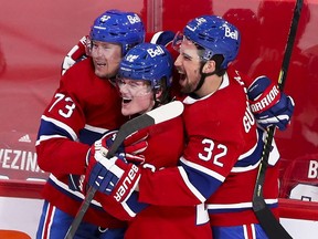 Canadiens' Tyler Toffoli, left, celebrates his game- and series- winning goal with team-mates Cole Caufield and Erik Gustafsson, right, Monday night at the Bell Centre.