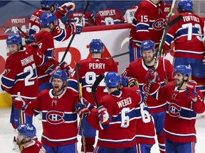 Canadiens players celebrate their sweep of the Winnipeg Jets following a 3-2 overtime win at the Bell Centre Monday night.
