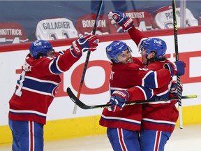 Montreal Canadiens Brendan Gallagher, left, and Ben Chiarot celebrate with Tyler Toffoli, right, after his game and series winning goal against the Winnipeg Jets druring overtime of National Hockey League playoff game in Montreal Monday June 7, 2021.