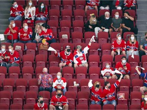 Socially distanced Montreal Canadiens fans cheer during a playoff game against the Winnipeg Jets in Montreal Monday June 7, 2021.