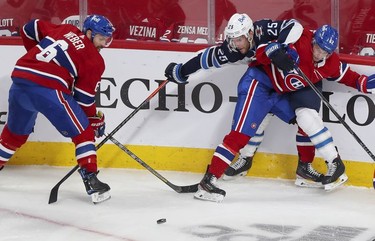 Artturi Lehkonen pins Winnipeg Jets' Paul Stastny against the boards as Shea Weber plays the puck during first-period action in Montreal on Monday, June 7, 2021.