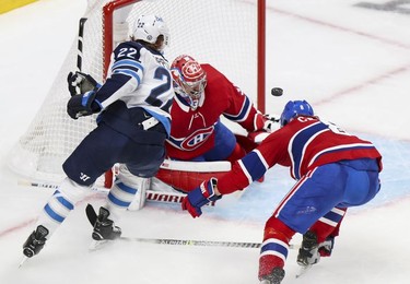 Defenceman  Ben Chiarot deflects shot by Winnipeg Jets Mason Appleton over goalie Carey Price during second period in Montreal Monday, June 7, 2021.