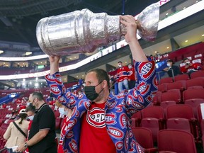 Canadiens fan Andy Mein hoists a Stanley Cup that he made while attending a second-round playoff game against the Winnipeg Jets at the Bell Centre.